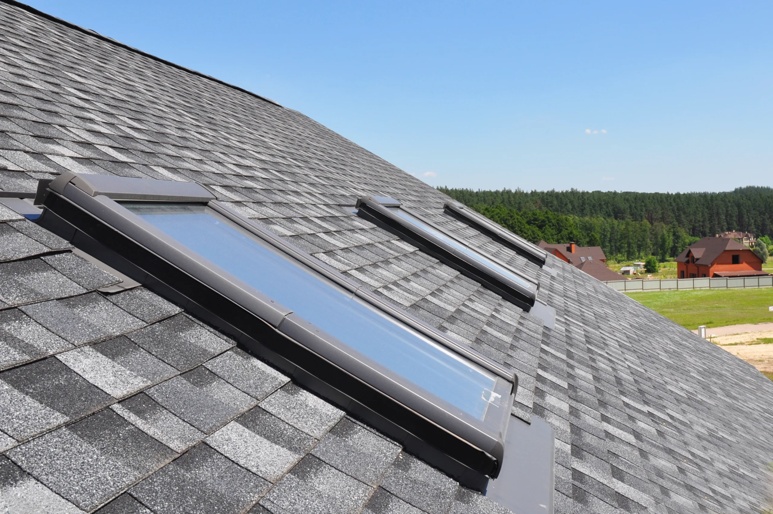 Attic,Skylight.,Asphalt,Shingles,House,Roofing,Construction,With,Attic,Roof A roof with skylights on it.